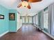 Large, sunny bedroom featuring hardwood floors, two ceiling fans, and lots of natural light at 800 W Lake Elbert Ne Dr, Winter Haven, FL 33881