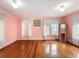 Bedroom featuring gleaming hardwood floors and soft pink walls at 800 W Lake Elbert Ne Dr, Winter Haven, FL 33881