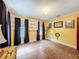 Bright bedroom with built-in shelves, hardwood floors, and warm yellow walls, perfect for a cozy retreat at 800 W Lake Elbert Ne Dr, Winter Haven, FL 33881