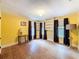 This bedroom features charming built-in shelves, ample natural light, and wood floors, creating a cozy space at 800 W Lake Elbert Ne Dr, Winter Haven, FL 33881
