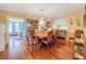 Formal dining room with hardwood floors, elegant chandelier, and ample space for entertaining guests at 800 W Lake Elbert Ne Dr, Winter Haven, FL 33881