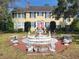 Charming two-story home with a front fountain and a landscaped yard at 800 W Lake Elbert Ne Dr, Winter Haven, FL 33881