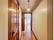 Hallway with hardwood floors leading to a bedroom with a window at 800 W Lake Elbert Ne Dr, Winter Haven, FL 33881