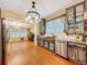 The eat-in kitchen features custom cabinets with glass doors, stainless appliances, and hardwood floors at 800 W Lake Elbert Ne Dr, Winter Haven, FL 33881