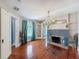 Bright living room featuring a decorative fireplace, hardwood floors, and ample natural light from multiple windows at 800 W Lake Elbert Ne Dr, Winter Haven, FL 33881