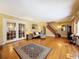 Spacious living room with hardwood floors, elegant decor, and French doors leading to other living spaces at 800 W Lake Elbert Ne Dr, Winter Haven, FL 33881