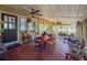 Cozy screened-in porch with brick flooring, ceiling fan, and plenty of space for relaxation and outdoor enjoyment at 800 W Lake Elbert Ne Dr, Winter Haven, FL 33881