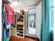 Well-organized walk-in closet with shelving and storage, with a small peek into the Primary bathroom at 800 W Lake Elbert Ne Dr, Winter Haven, FL 33881