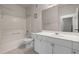 Bathroom featuring a large mirror, vanity with white cabinets and a tub/shower combination at 4014 Hemingway Cir # 4014, Haines City, FL 33844
