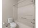 Well-lit bathroom featuring a tub/shower and a white toilet at 4014 Hemingway Cir # 4014, Haines City, FL 33844