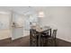 Cozy dining area with a ceiling light fixture and adjoining kitchen featuring white cabinets at 4014 Hemingway Cir # 4014, Haines City, FL 33844