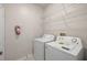 Functional laundry room with white washer, dryer, and storage shelves at 4014 Hemingway Cir # 4014, Haines City, FL 33844