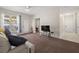 Living room with carpet, sliding glass door to deck, and view into hall and adjacent room at 4014 Hemingway Cir # 4014, Haines City, FL 33844