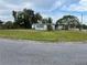 A blue single-Gathering home with a fenced-in yard, surrounded by lush trees, sits on a corner lot at 5137 Polaris St, Orlando, FL 32819