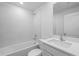Modern bathroom features a bathtub, shower, and a sleek vanity with ample counter space at 1 Zinnia E Ln, Poinciana, FL 34759