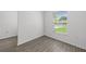 Neutral toned bedroom with wood look floors and a bright window at 1 Zinnia E Ln, Poinciana, FL 34759