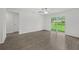 Bedroom with hardwood floors, ceiling fan, and sliding glass door to backyard at 1 Zinnia E Ln, Poinciana, FL 34759