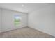 Simple bedroom with carpet, a window with blinds and white walls at 1 Zinnia E Ln, Poinciana, FL 34759