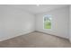 Cozy bedroom with neutral carpet and natural light from the window at 1 Zinnia E Ln, Poinciana, FL 34759