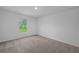 Carpeted bedroom with a bright window and neutral walls at 1 Zinnia E Ln, Poinciana, FL 34759