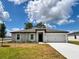 Charming single-story home featuring a two-car garage and a well-maintained front yard at 1 Zinnia E Ln, Poinciana, FL 34759