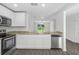 Open kitchen with stainless steel appliances, breakfast bar, and view of the living area at 1 Zinnia E Ln, Poinciana, FL 34759