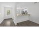 Open-concept layout with kitchen island, stainless appliances, and adjacent entry at 1 Zinnia E Ln, Poinciana, FL 34759