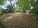 A spacious backyard view reveals the house and mature trees, highlighting the property's potential at 401 Pine Dr, Sanford, FL 32773