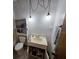 Bathroom with hanging light fixtures, pedestal sink, and a neutral color palette at 401 Pine Dr, Sanford, FL 32773