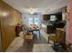 Dining area with wood paneling, tiled floor, adjacent kitchen access, and natural light through french doors at 401 Pine Dr, Sanford, FL 32773