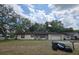 Charming single-story home with a combination of siding and stone accents and a well-maintained lawn at 401 Pine Dr, Sanford, FL 32773