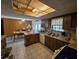 Traditional kitchen with breakfast bar, wood cabinetry, and tile flooring that flows into the dining area at 401 Pine Dr, Sanford, FL 32773