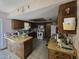 Functional kitchen featuring ample counter space, wood cabinets, modern appliances, and tiled flooring at 401 Pine Dr, Sanford, FL 32773