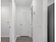 Hallway with wood-look flooring and access to laundry area and other rooms at 414 Caribbean Ct, Poinciana, FL 34759