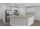Bright kitchen with granite countertops, white cabinets, and stainless steel appliances at 414 Caribbean Ct, Poinciana, FL 34759
