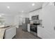 Modern kitchen featuring stainless steel appliances, granite countertops, and wood flooring at 414 Caribbean Ct, Poinciana, FL 34759