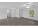 Open living room boasts stylish flooring, ceiling fan, and a bright, airy feel at 414 Caribbean Ct, Poinciana, FL 34759