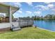A charming gray deck overlooking the water with seating at 492 Caribbean Dr, Lakeland, FL 33803