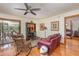 Cozy living room with hardwood floors, eclectic decor, and sliding glass doors to the patio at 492 Caribbean Dr, Lakeland, FL 33803