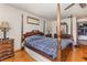 Bright main bedroom showcasing a four-poster bed, dresser, and closet access at 492 Caribbean Dr, Lakeland, FL 33803