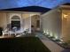 Night view of the home's exterior, featuring a manicured lawn and inviting entryway at 2057 Swift Rd, Oviedo, FL 32766
