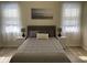 Comfortable main bedroom features two windows, neutral paint, a ceiling fan, and wood-look floors at 2057 Swift Rd, Oviedo, FL 32766