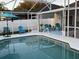 Inviting screened-in pool area with white fencing and furniture for relaxing outdoors at 2057 Swift Rd, Oviedo, FL 32766