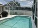 Screened-in pool area with a beautiful swimming pool, grill and plenty of lounging space at 2057 Swift Rd, Oviedo, FL 32766