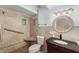 Bathroom featuring tile surround walk-in shower, vanity with modern fixtures at 220 Escambia Dr, Winter Haven, FL 33884