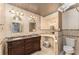 Bathroom featuring double sink vanity, decorative mirrors and matching light fixtures at 220 Escambia Dr, Winter Haven, FL 33884