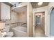 Bathroom featuring tile surround, soaking tub with shower and tiled accent trim at 220 Escambia Dr, Winter Haven, FL 33884