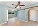 Light blue bedroom with tile floors, open archway, and access to the bathroom at 220 Escambia Dr, Winter Haven, FL 33884