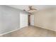 Neutral bedroom featuring tile floors, a ceiling fan and a closet with bi-fold doors at 220 Escambia Dr, Winter Haven, FL 33884