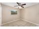 Bedroom with tile floors, ceiling fan, and a view of the yard through the window at 220 Escambia Dr, Winter Haven, FL 33884